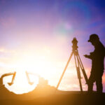 silhouette survey engineer working in a building site over Blurred construction worker on construction site